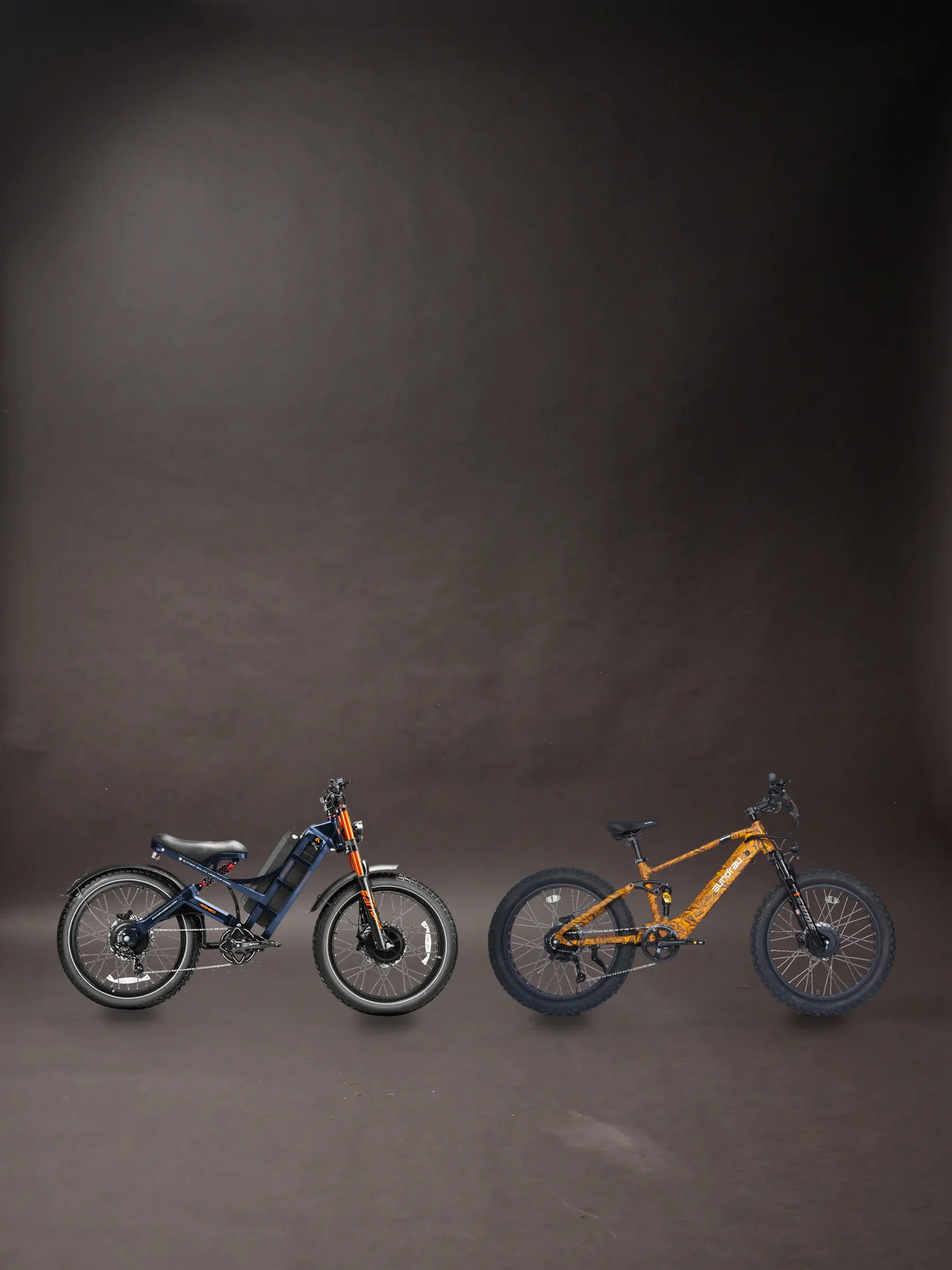 hunting ebike guide banner: an Eahora Romeo Ultra II in blue and a Eunorau DEFENDER S 2.0 in Dry Grass Camo standing side by side on a charcoal studio floor