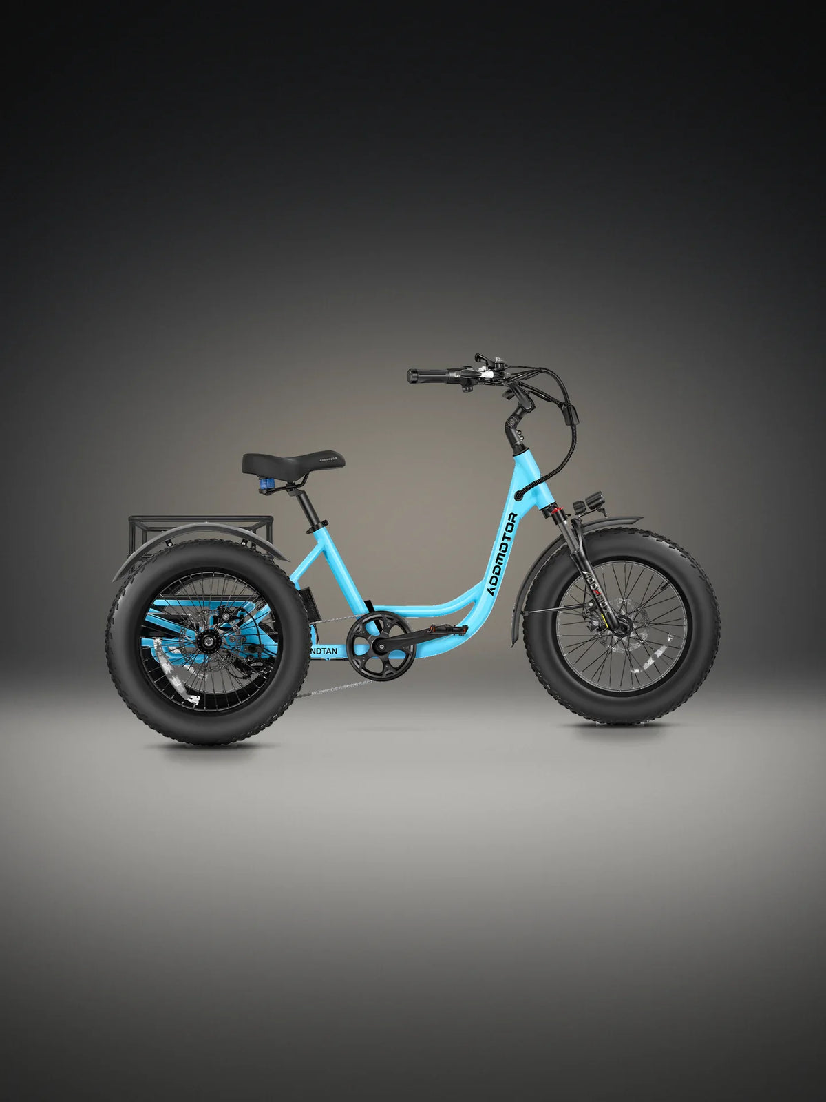 Addmotor Landtan fat-tire trike in Blue on a lit studio floor, side view, with its light blue step-through frame, black 20 by 4.0 tires on all three wheels, a sprung black saddle and the rear rack