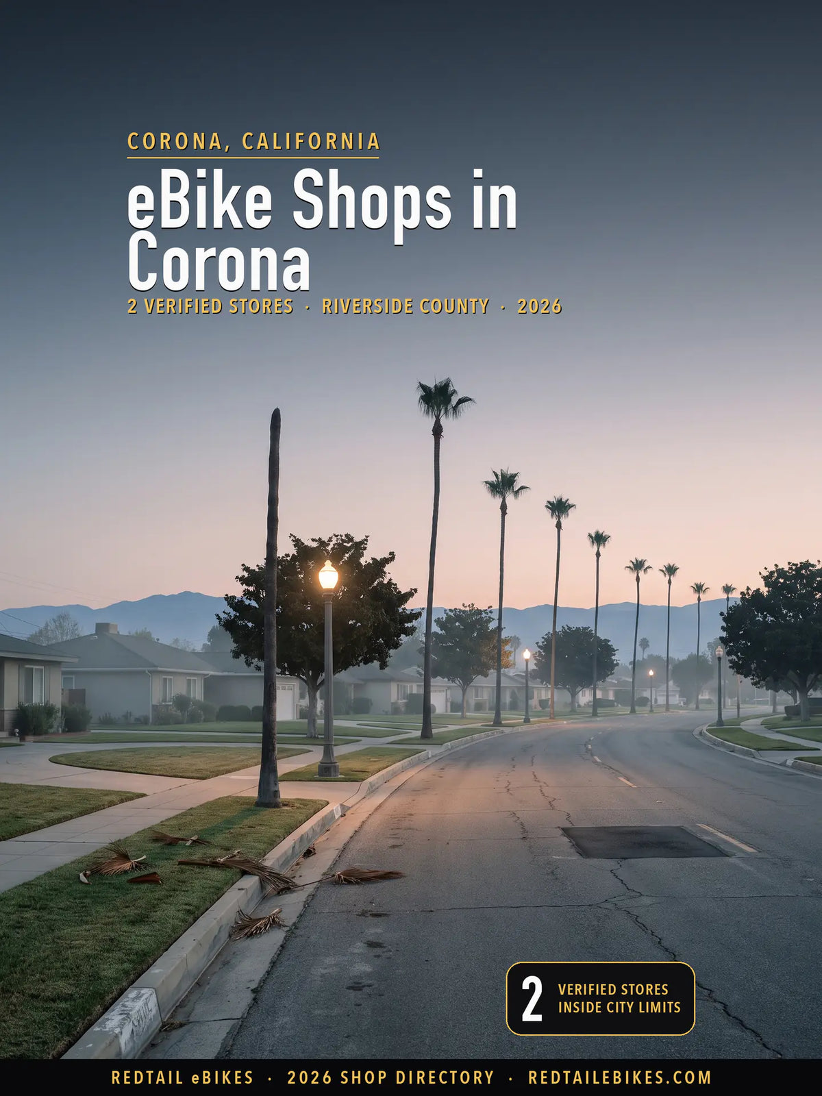 Grand Boulevard in Corona, California at first light, the circular boulevard curving between mature Mexican fan palms and lit period streetlights with the Santa Ana Mountains on the horizon
