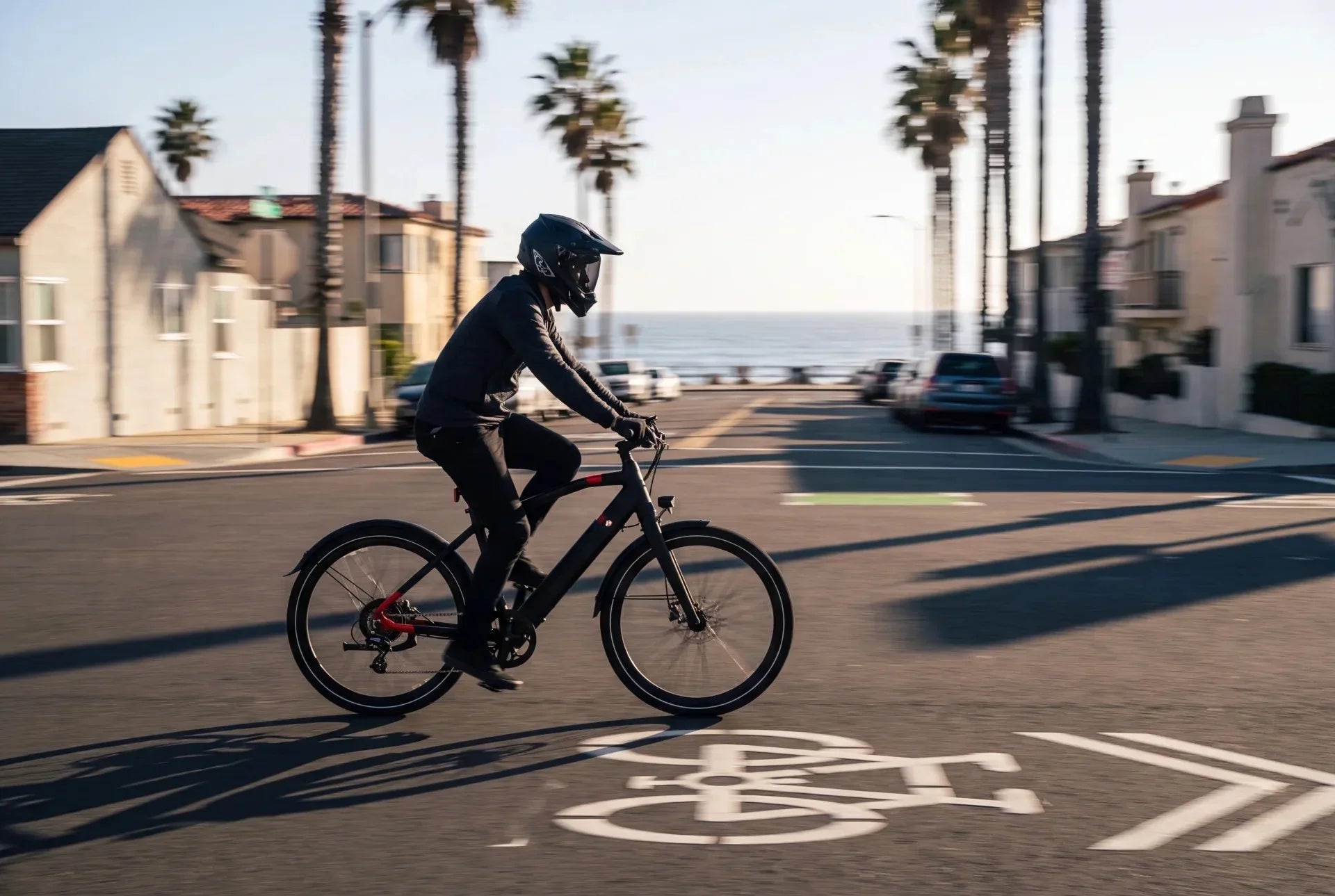 Rider on a Class 3 electric bike in a marked California bike lane at sunset