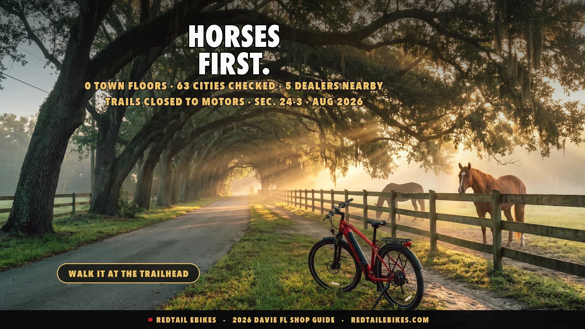 Electric bike beside a split-rail fence on a canopy oak road in Davie horse country at dawn with two horses in a paddock