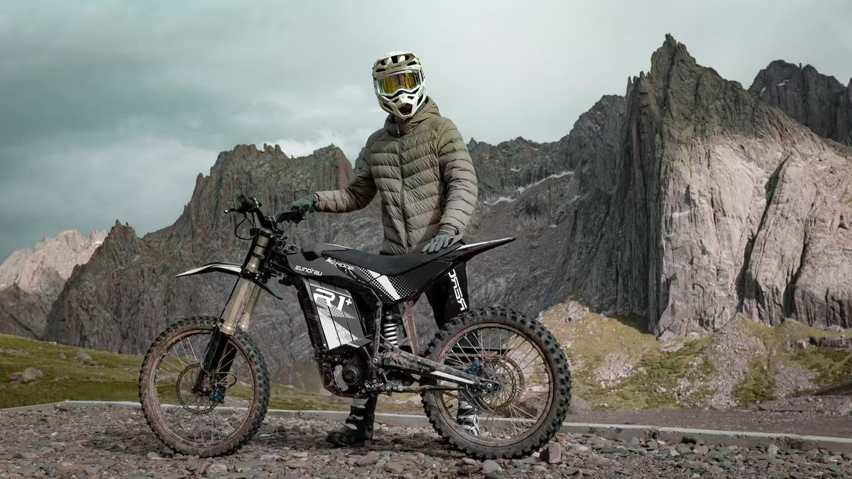 Eunorau R1+ electric dirt bike in Black on a gravel track below mountain peaks, Eunorau's own photograph
