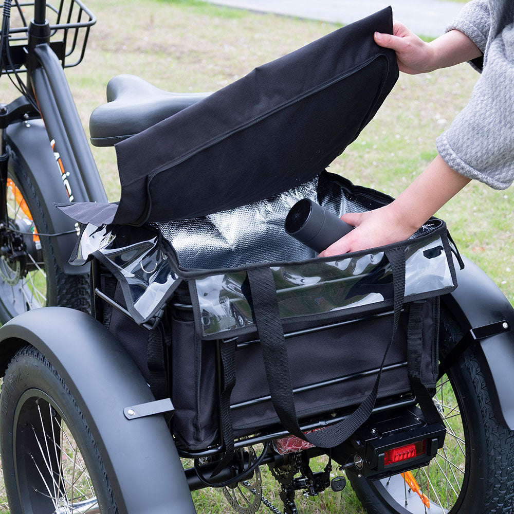 A hand opens the Zeus's rear basket bag to show its lining