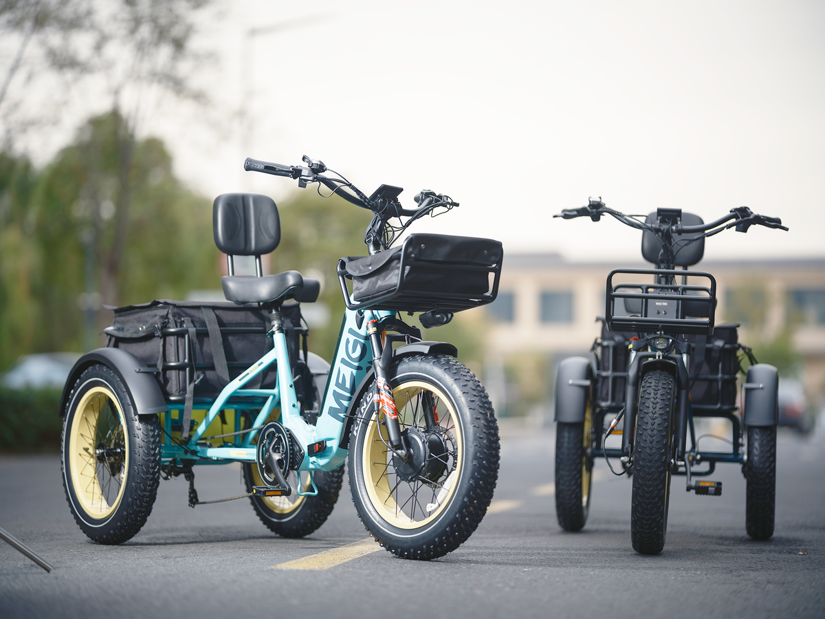 Two MG2301 Silverado HD trikes on a paved road, one in Blue