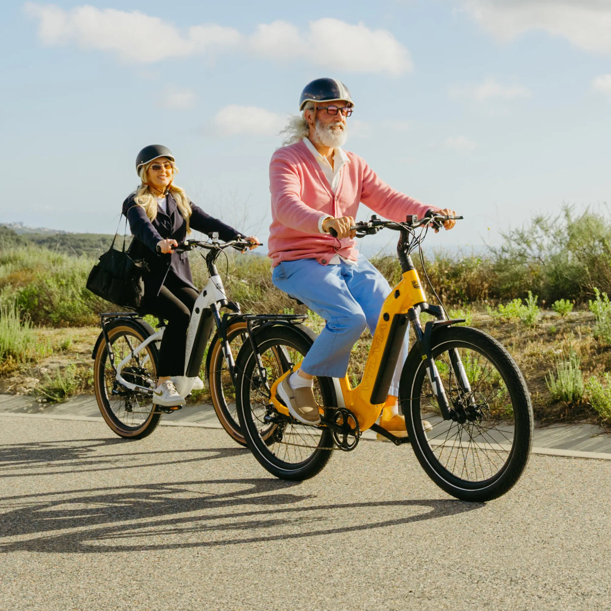 Two riders on Zeal LT7 commuters on a paved path above the coast