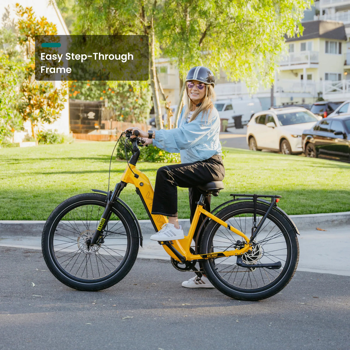 Rider stepping through the frame of an orange Zeal LT7 on a suburban street