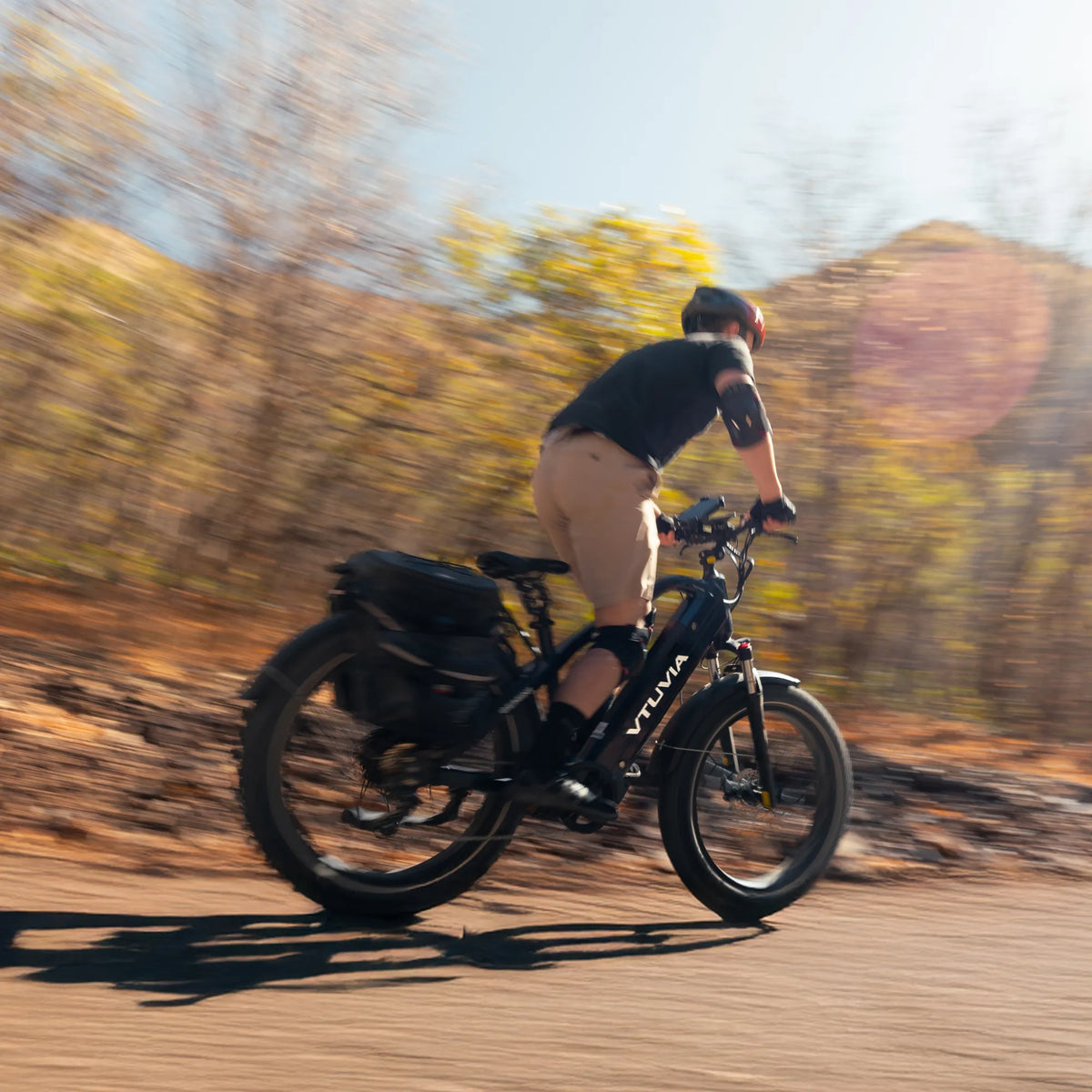 Rider on a Gemini with panniers on a red-rock desert trail