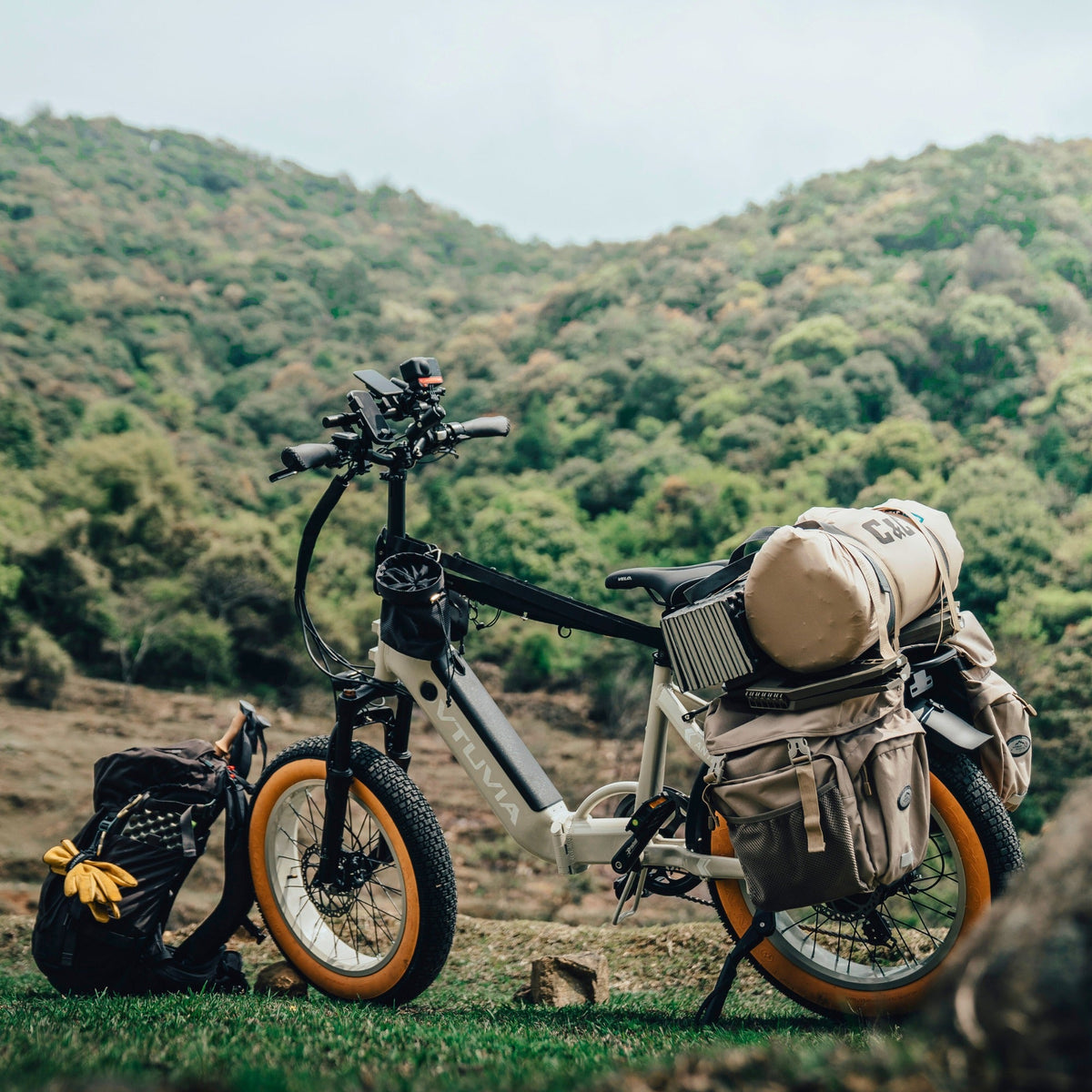Cream SX20 loaded with camping bags on a hillside