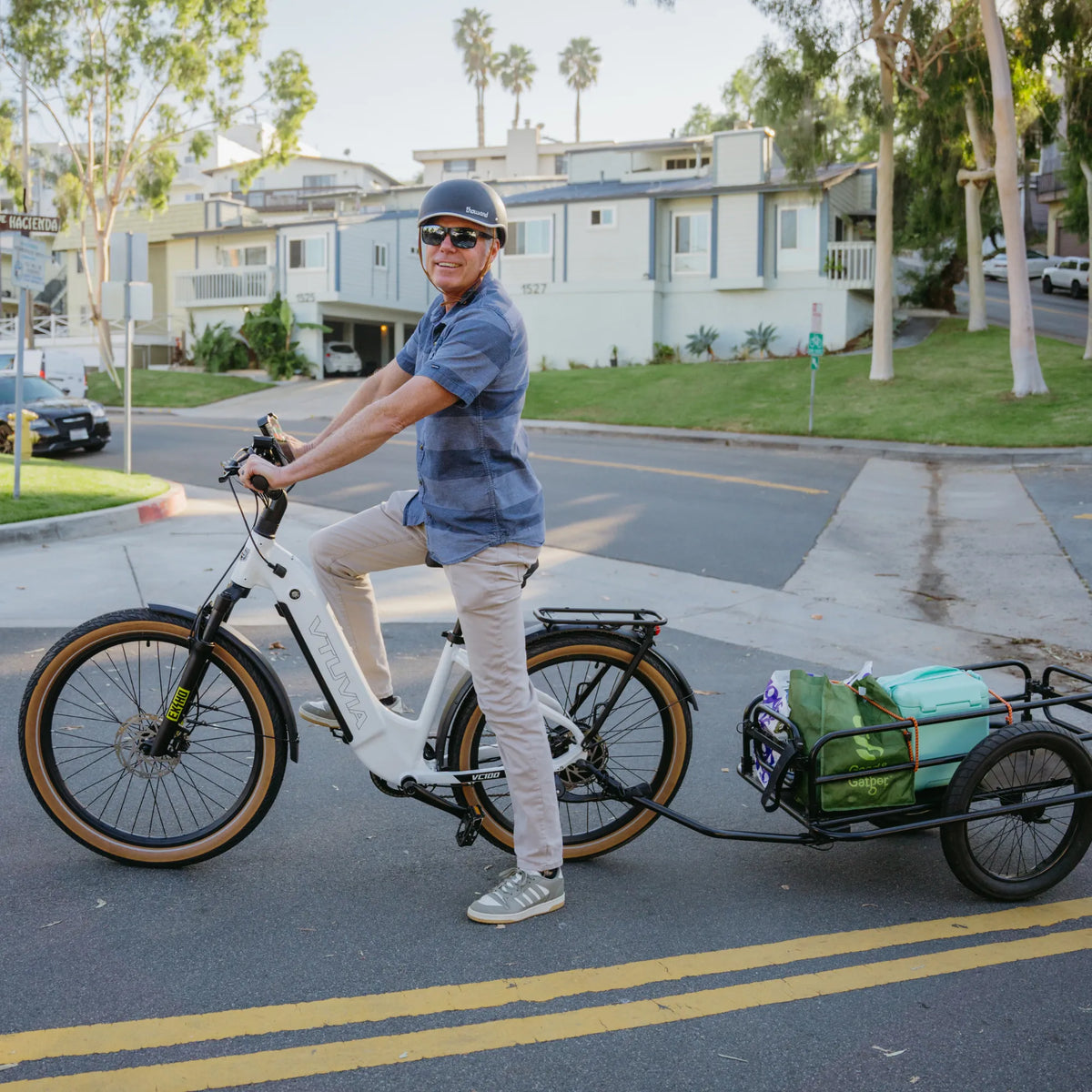 Rider on a white Zeal XT8 towing a cargo trailer on a residential street