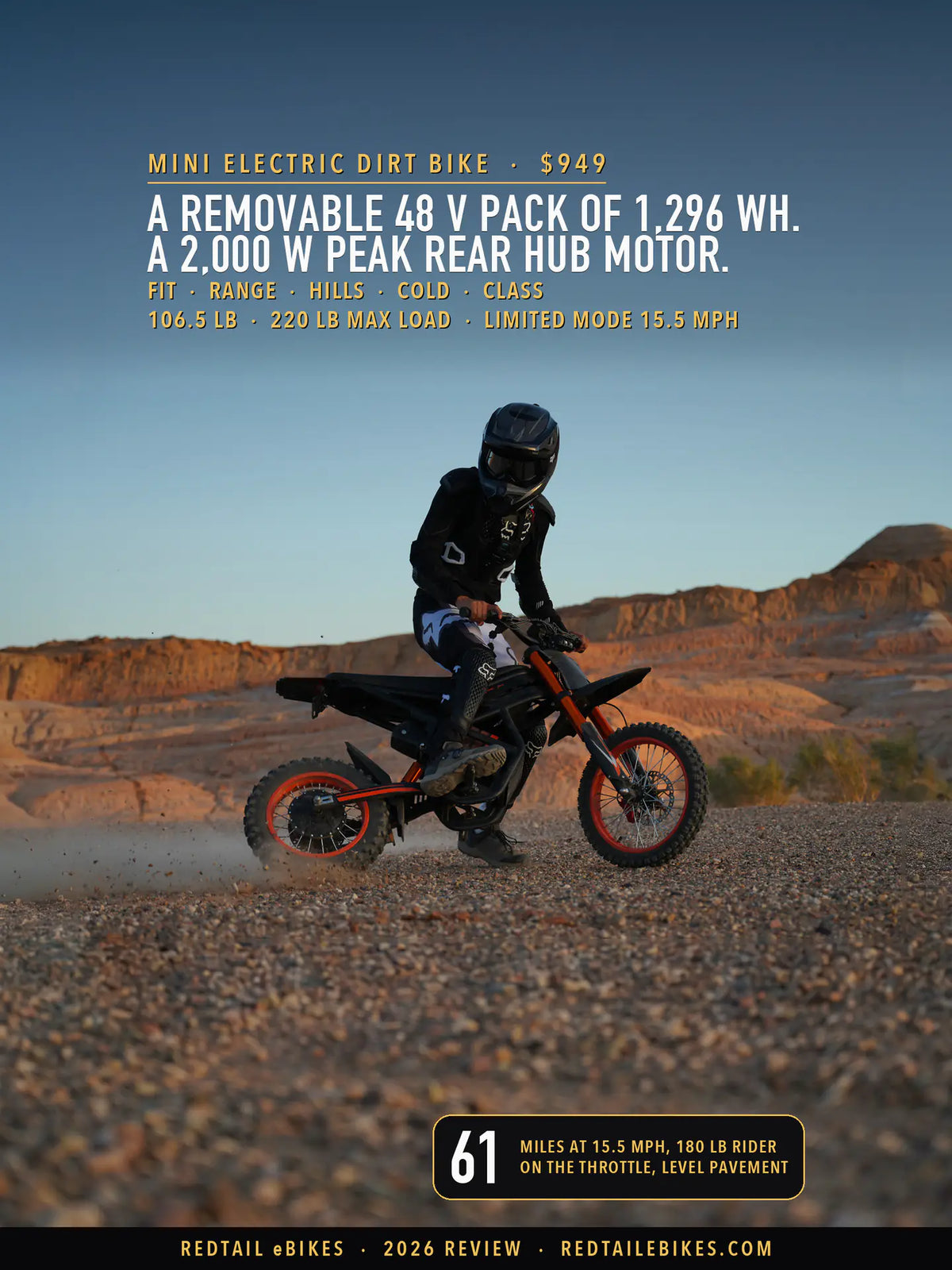 A rider in a full-face helmet, goggles, chest protector, gloves and boots turns the Riding'times GT54 mini electric dirt bike on loose gravel below eroded rock in low evening sun, the rear tire throwing up gravel