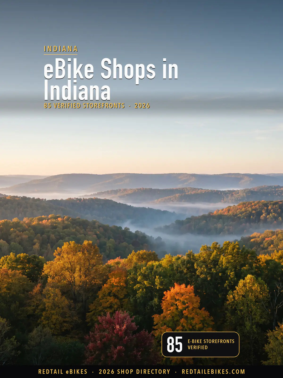 Cover reading eBike Shops in Indiana, 85 verified storefronts, over a sunrise vista of the wooded hills of Brown County State Park in October color with fog in the valleys