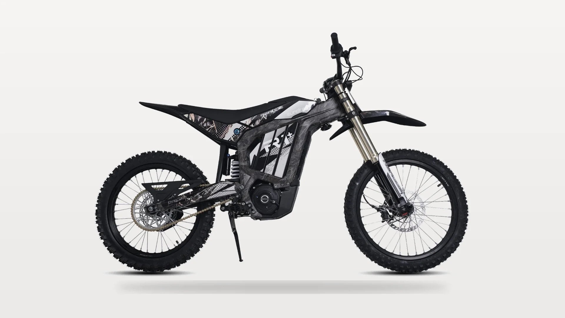 Eunorau R1+ electric dirt bike in studio profile showing its 19-inch front wheel, gold-anodized fork and footpegs