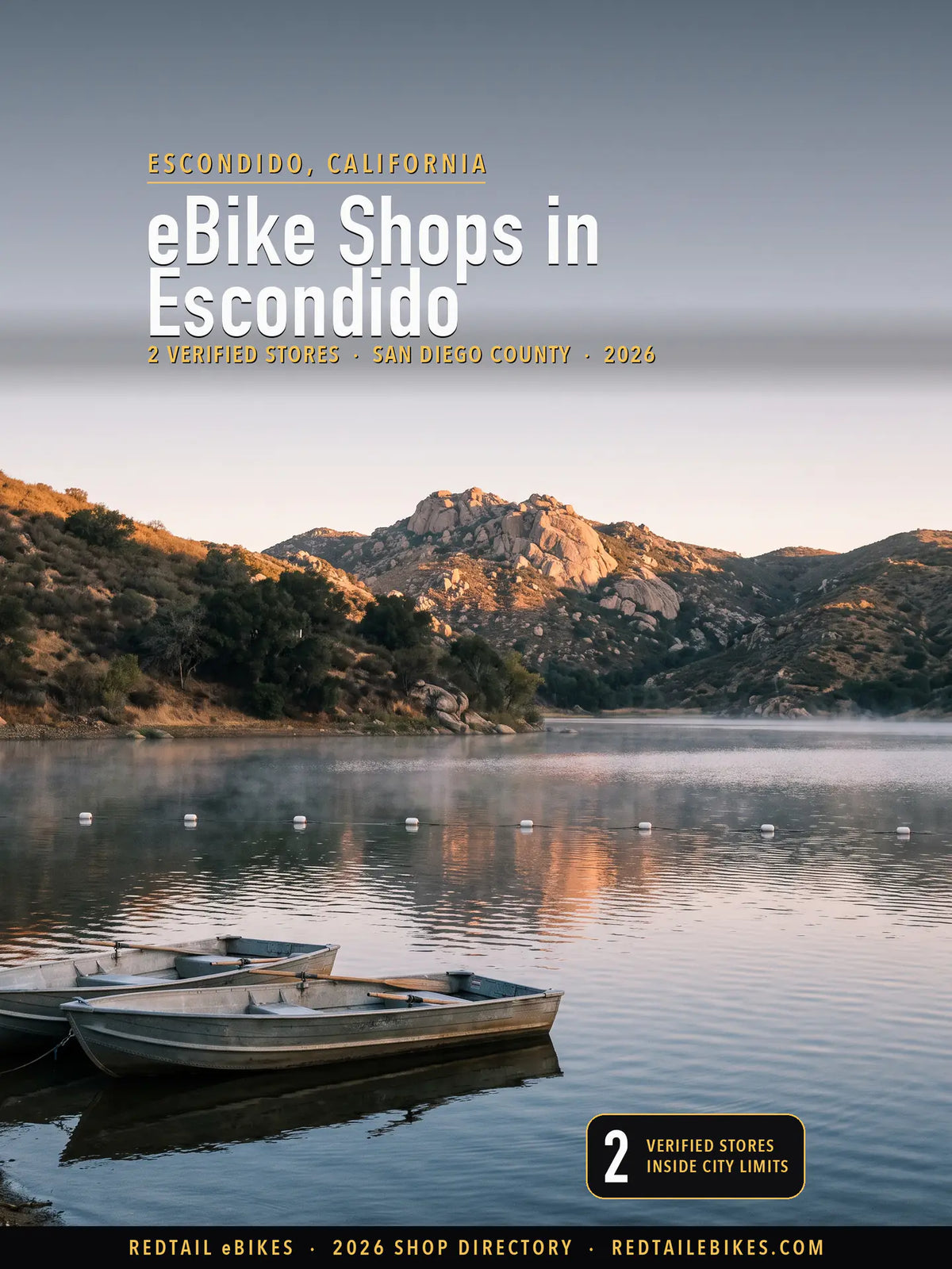 Dawn on Dixon Lake in Escondido, still water and a line of white buoys below chaparral hills and a rocky peak, two empty rental rowboats at the near shore