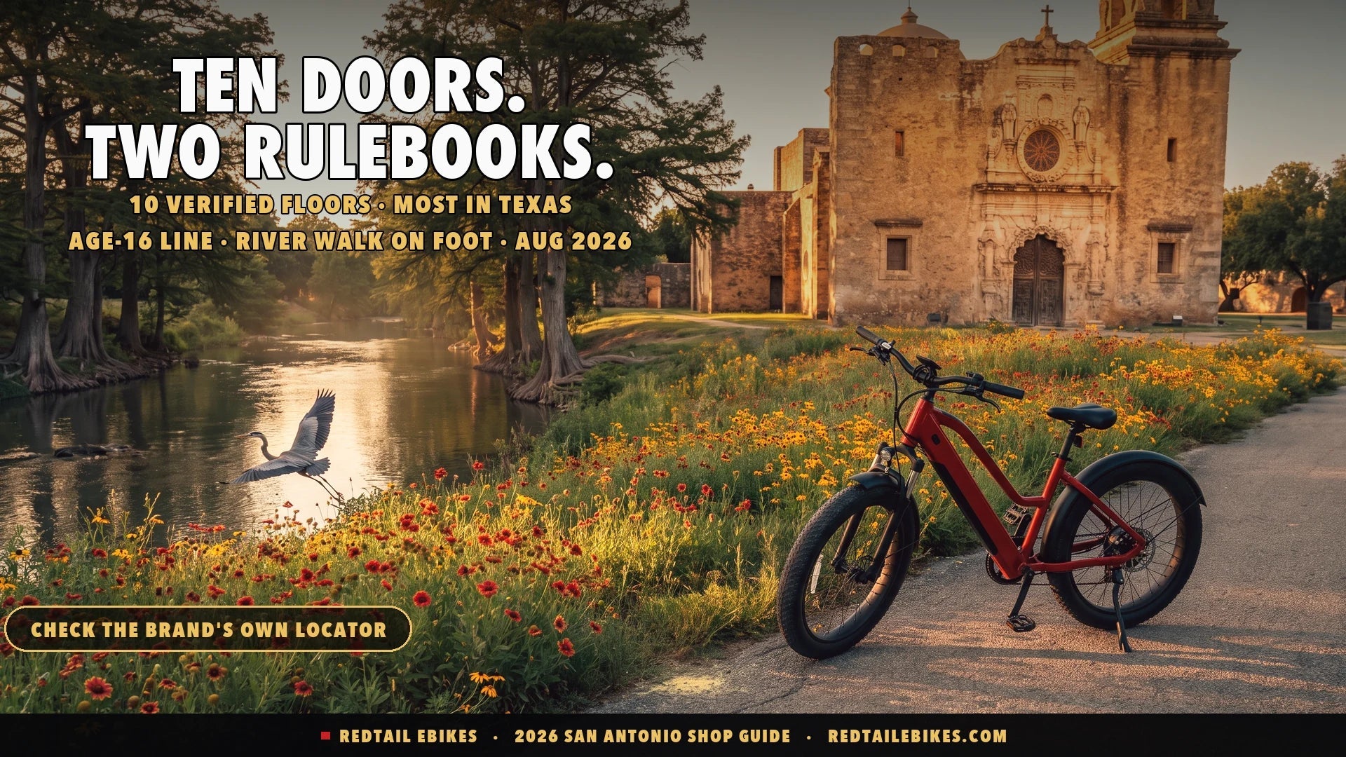 Red step-through electric bike beside the Mission Reach trail at golden hour with Mission San José beyond wildflowers in San Antonio