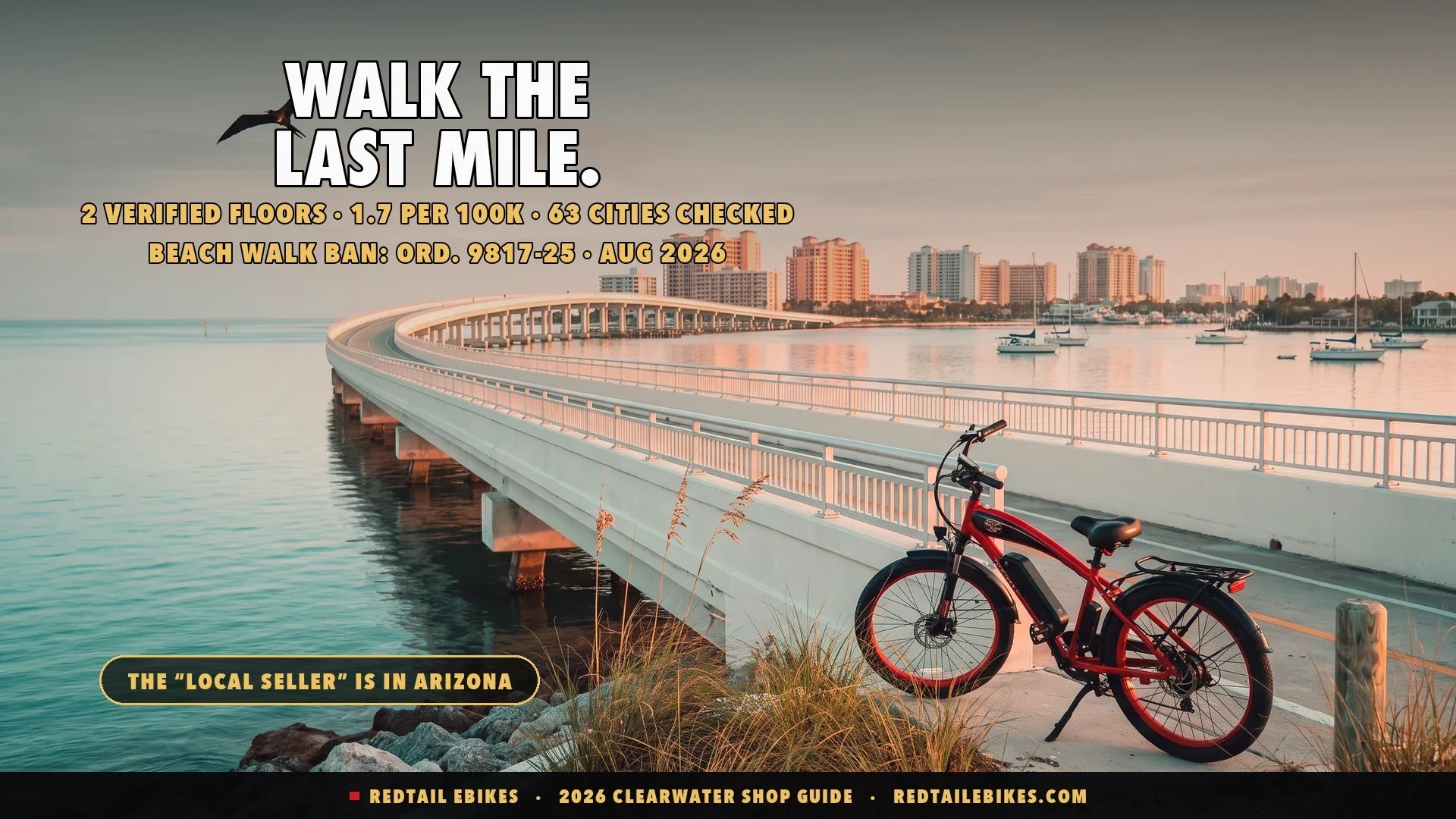Electric bike at the base of the Memorial Causeway path with Clearwater Beach and gulf water at first light