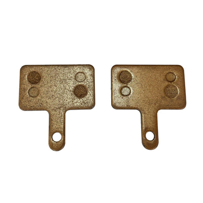 Two brake pads with a tab and holes for the pin