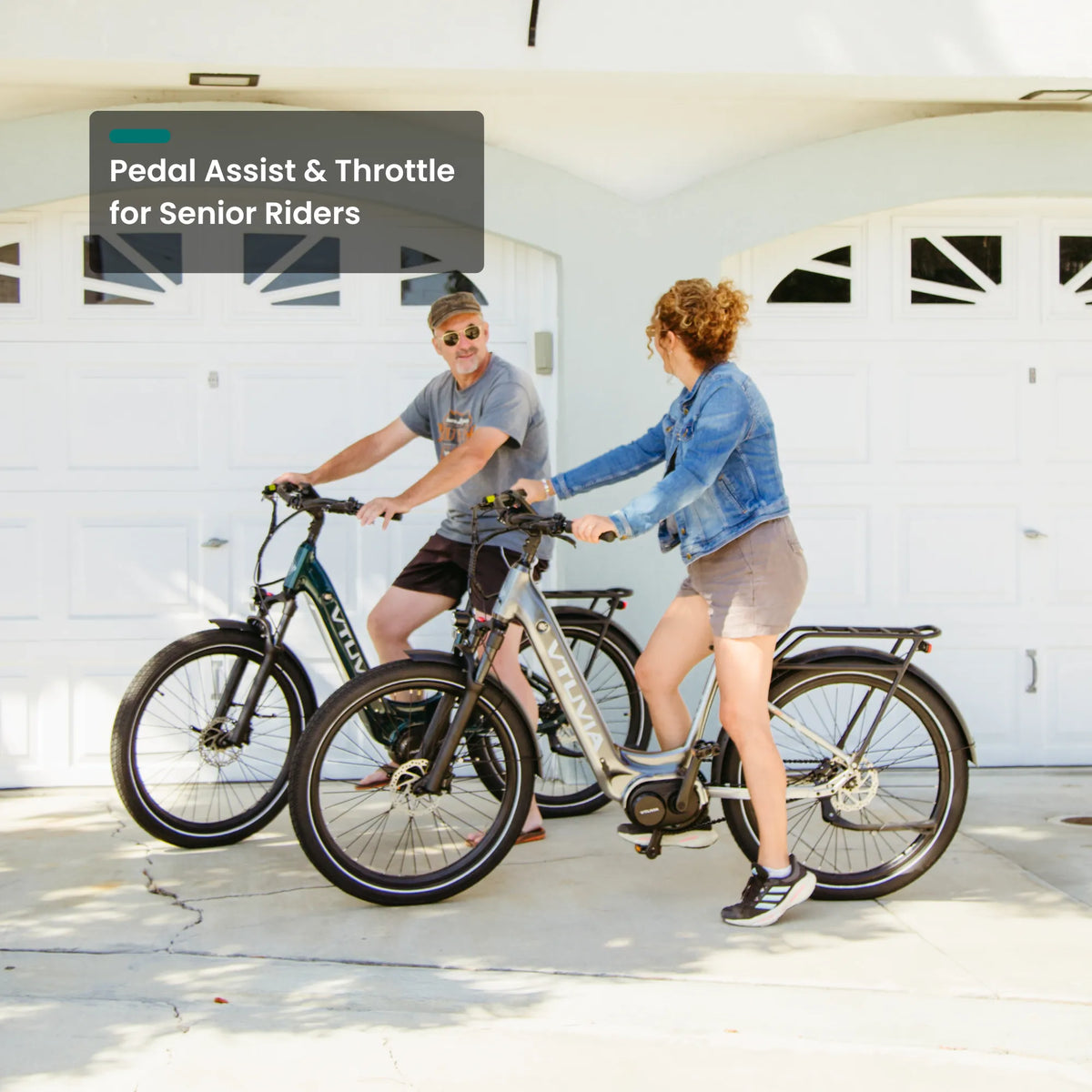 Two riders straddling CMB bikes in a driveway