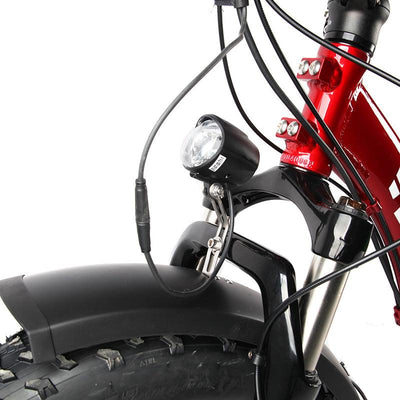 The headlight fitted above the fender of a red VTUVIA