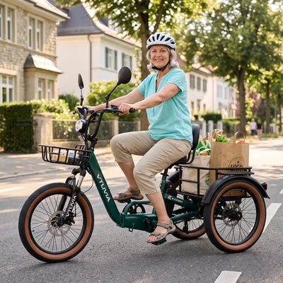 Rider in a helmet on a green E-Cozy trike with groceries in the rear basket