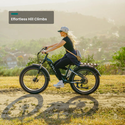 Rider climbing a dirt hill on a Reindeer 2.0 with the sun behind