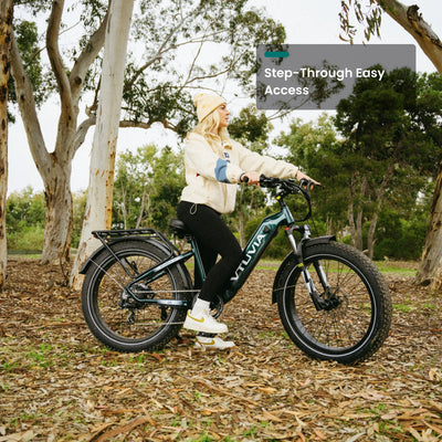 Rider stepping onto a dark green Reindeer 2.0 under eucalyptus trees