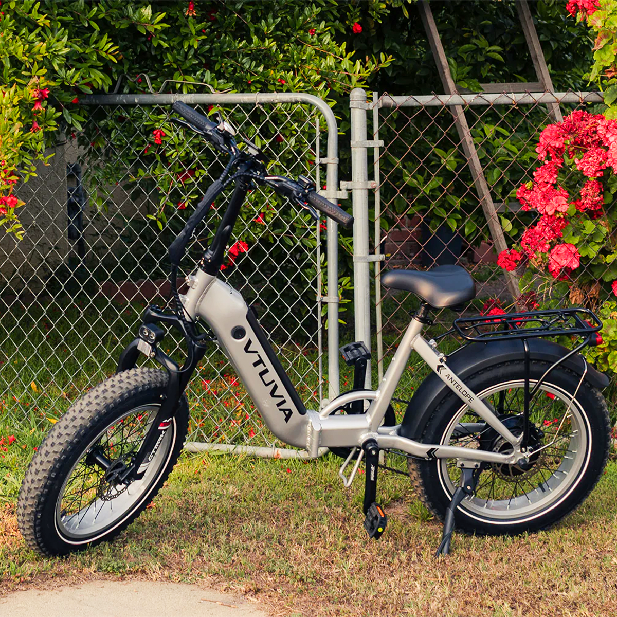 A silver VTUVIA SF20H by a fence