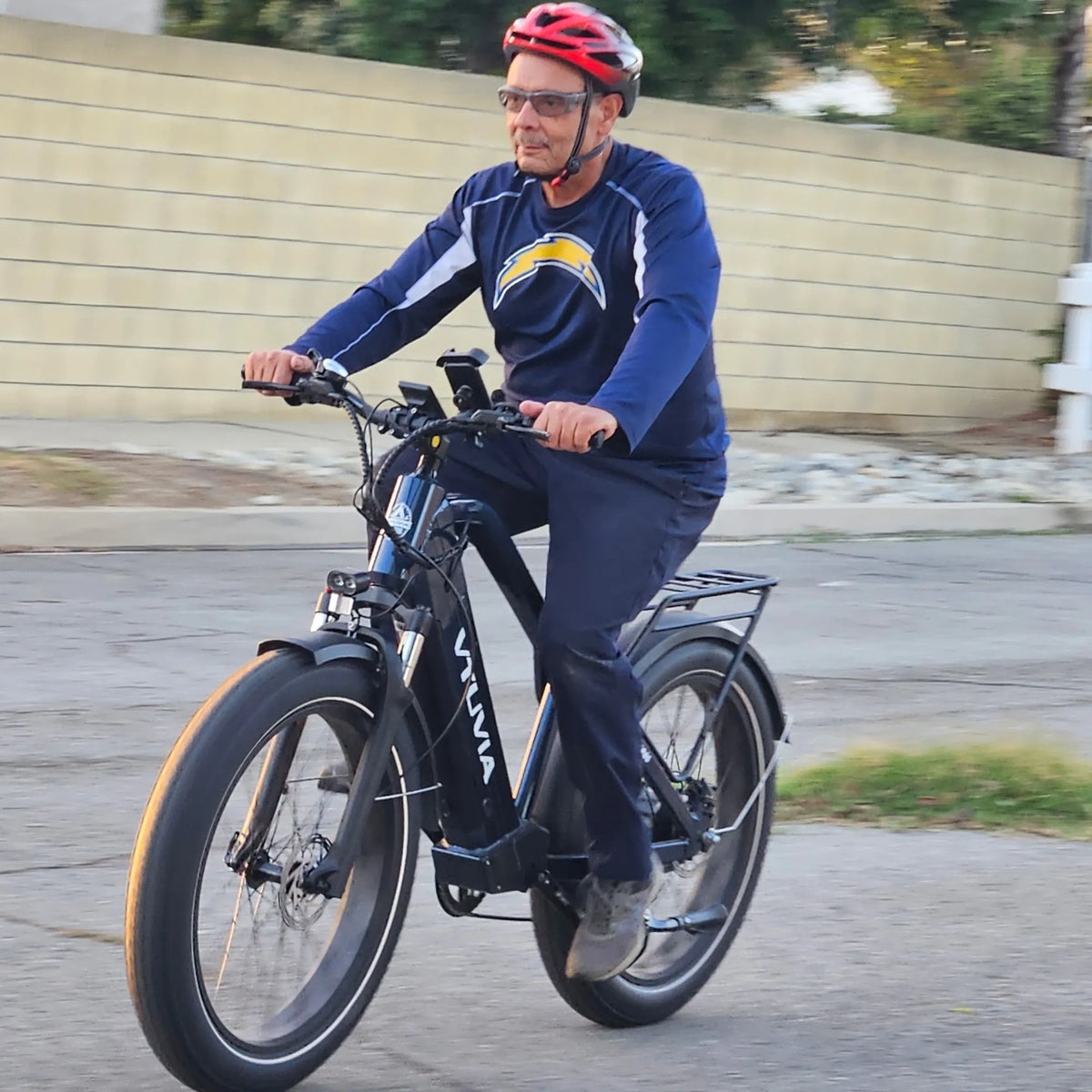 Older rider on a dark Gemini on a neighborhood street
