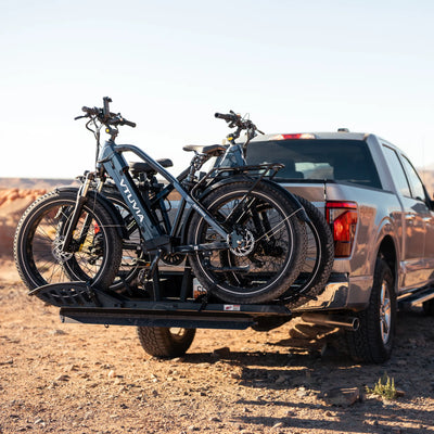 Two Gemini bikes on a hitch rack behind a pickup truck