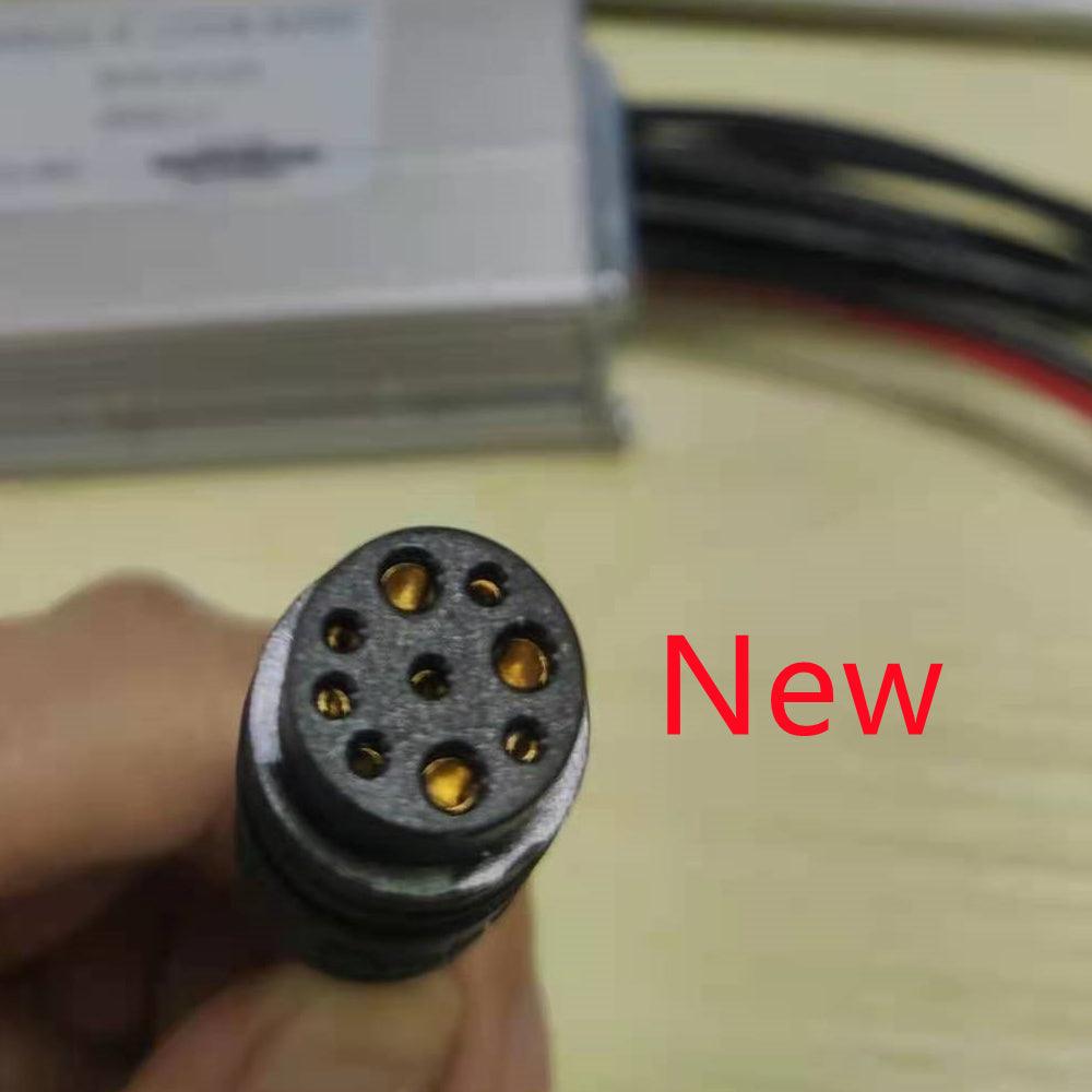 The new nine-pin controller plug, held in a hand