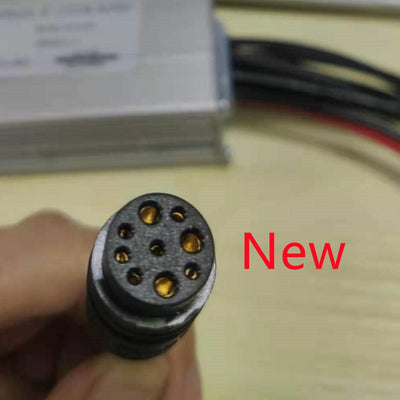 The new nine-pin controller plug, held in a hand