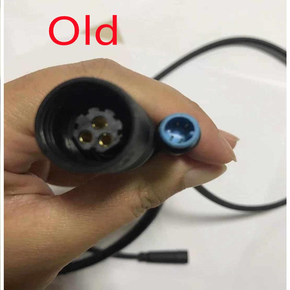 The old three-pin controller plug, held in a hand