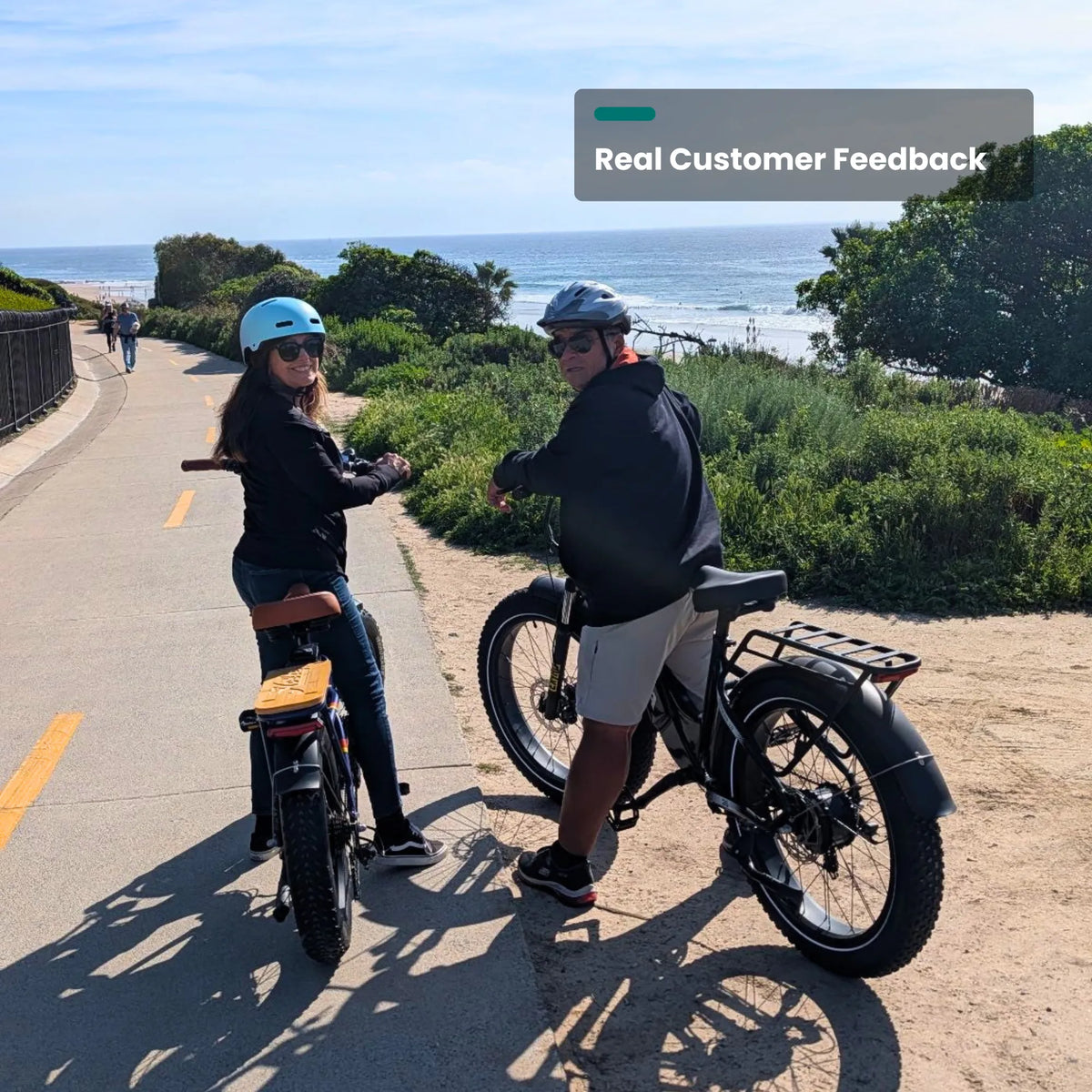 Two riders on Reindeer 2.0 bikes on a coastal path