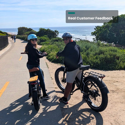 Two riders on Reindeer 2.0 bikes on a coastal path