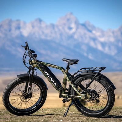 Camo SN100 parked on a gravel road below the Tetons