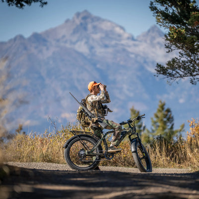 Hunter glassing from beside an SN100 on a mountain road